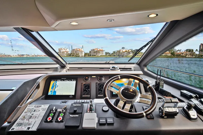 Slide: The Image of Cockpit view of 2017 Azimut 72 Flybridge yacht with navigation controls and waterfront scenery. - 40