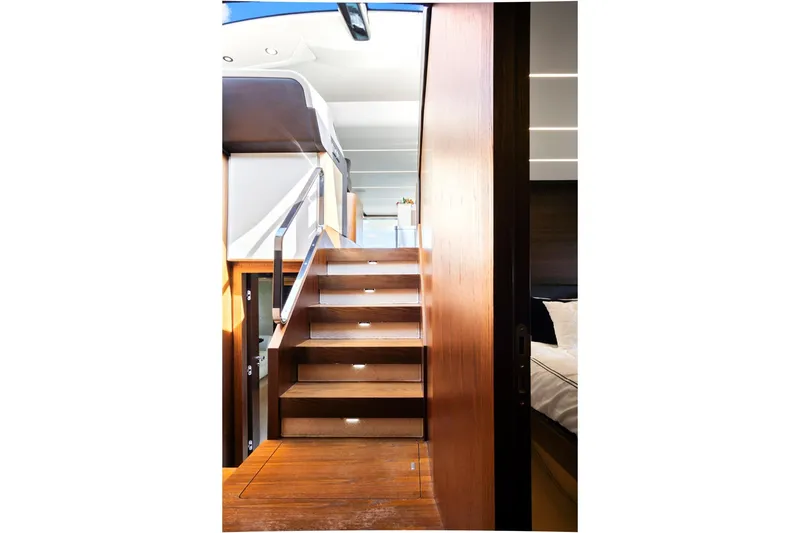 Slide: The Image of Interior staircase of 2017 Azimut 72 Flybridge yacht, featuring sleek wooden design. - 41