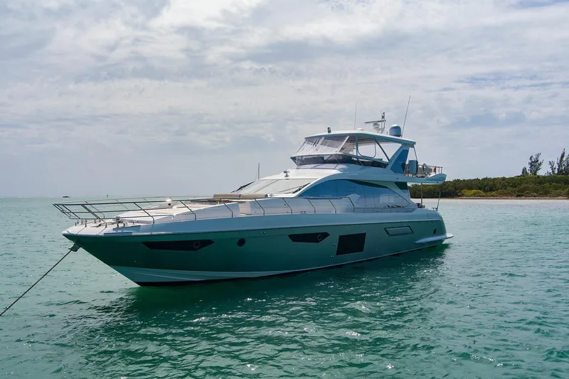 Slide: The Image of Luxurious 2017 Azimut 72 Flybridge yacht anchored in serene turquoise waters. - 6