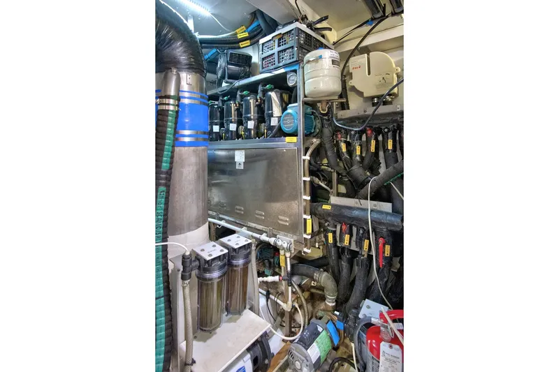 Slide: The Image of Engine room of 2017 Azimut 72 Flybridge yacht, showcasing complex machinery and piping. - 63