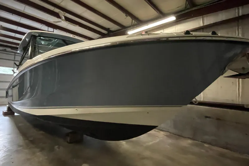 Slide: The Image of 2025 Boston Whaler 330 Vantage boat in a garage, side view. - 1