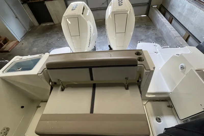 Slide: The Image of 2025 Boston Whaler 330 Vantage boat interior with dual Mercury engines and seating area. - 3