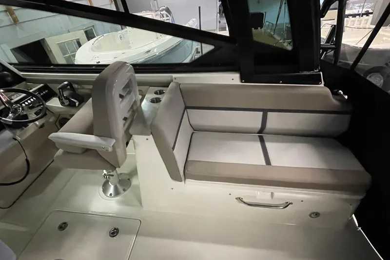 Slide: The Image of 2025 Boston Whaler 330 Vantage interior with seating and helm station. - 5