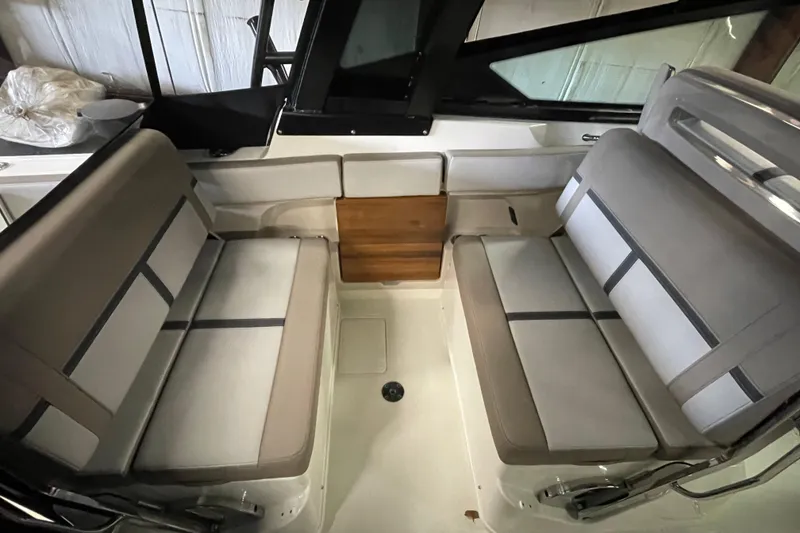 Slide: The Image of 2025 Boston Whaler 330 Vantage interior seating with gray cushions and sleek design. - 6