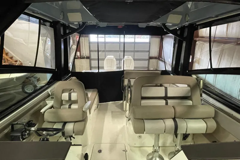Slide: The Image of 2025 Boston Whaler 330 Vantage interior with seating and helm, showcasing luxury design. - 8