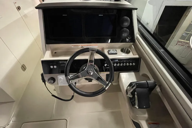 Slide: The Image of 2025 Boston Whaler 330 Vantage helm with steering wheel and control panel. - 9
