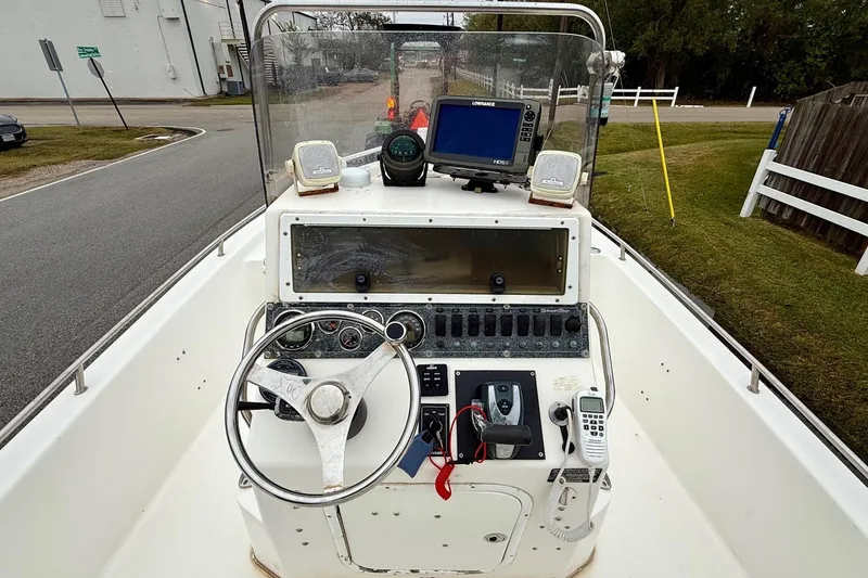 Slide: The Image of 2003 Blazer 2220 Bay boat dashboard with steering wheel and navigation equipment. - 10