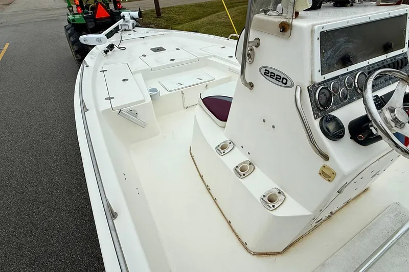 Slide: The Image of 2003 Blazer 2220 Bay boat interior with steering console and seating. - 11