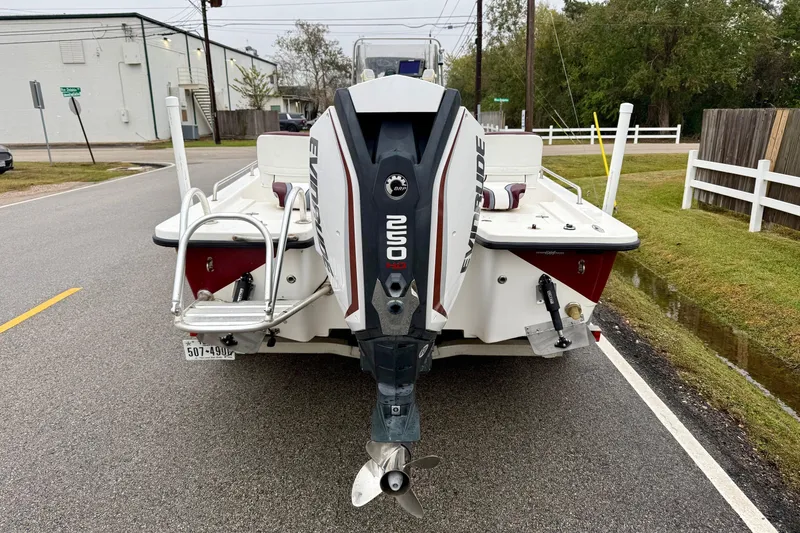 Slide: The Image of 2003 Blazer 2220 Bay boat with Evinrude motor on a street. - 3