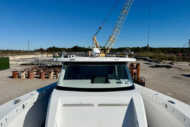 Slide: The Image of 2021 Gulf Crosser 44 boat at a construction site with cranes in the background. - 10