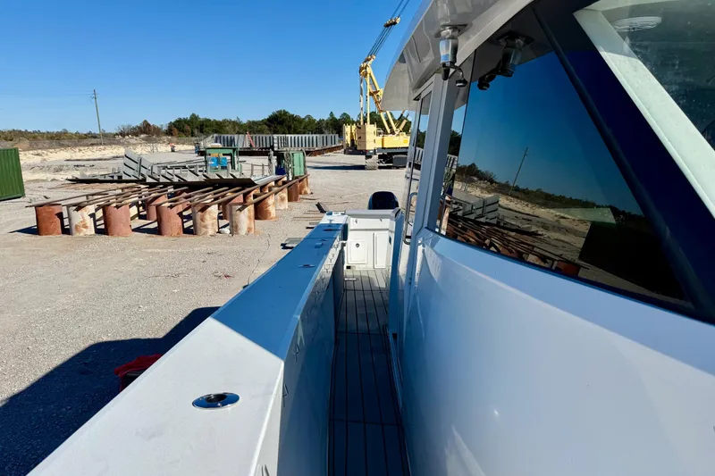 Slide: The Image of 2021 Gulf Crosser 44 boat docked in an industrial area with construction equipment. - 14