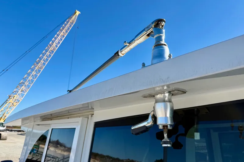 Slide: The Image of Close-up of a 2021 Gulf Crosser 44 boat detail with a crane in the background. - 16