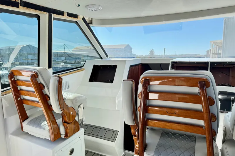 Slide: The Image of Interior of 2021 Gulf Crosser 44 yacht with elegant wooden seating and panoramic windows. - 19