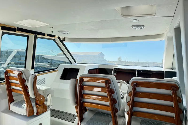Slide: The Image of Interior of 2021 Gulf Crosser 44 yacht with wooden chairs and panoramic windows. - 20