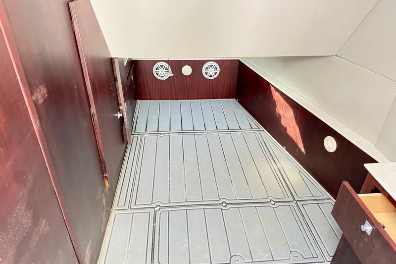 Slide: The Image of Interior cabin of 2021 Gulf Crosser 44 boat with wood paneling and gray flooring. - 25