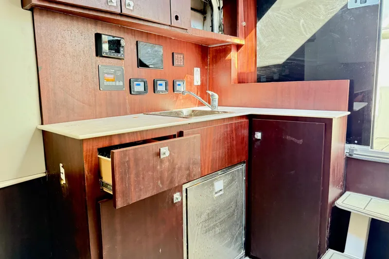 Slide: The Image of Interior of 2021 Gulf Crosser 44 yacht kitchen with wooden cabinets and modern appliances. - 26