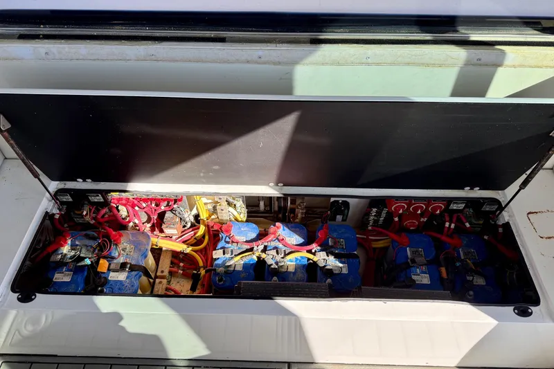 Slide: The Image of Battery compartment of a 2021 Gulf Crosser 44 boat, featuring multiple blue batteries and wiring. - 29