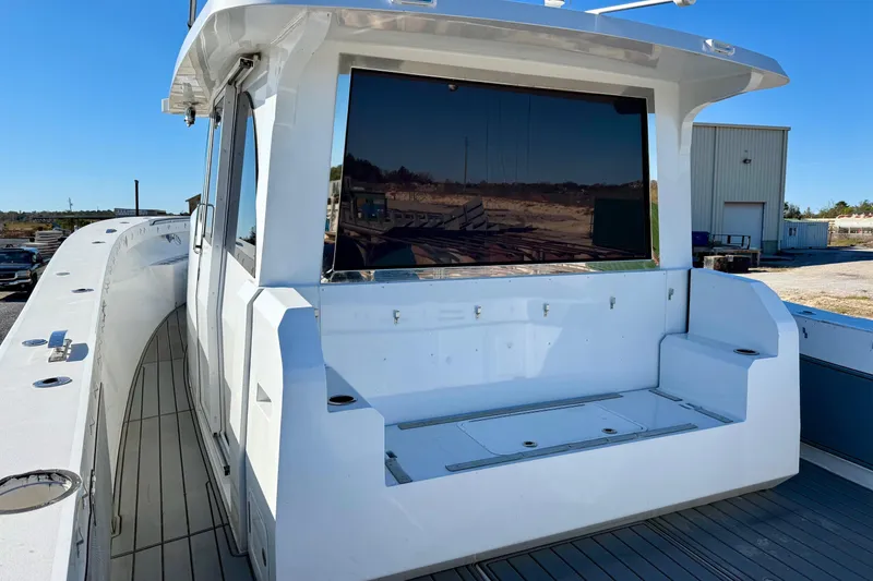 Slide: The Image of 2021 Gulf Crosser 44 boat with sleek white exterior and spacious deck area. - 32
