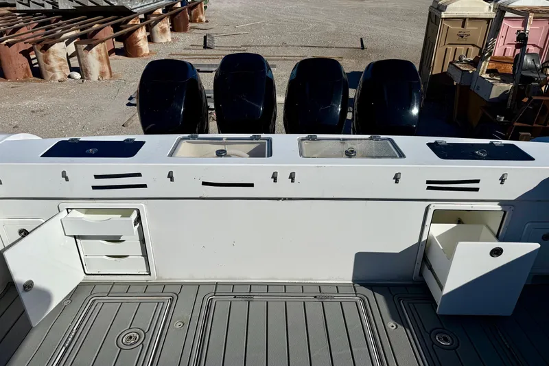 Slide: The Image of Gulf Crosser 44 boat deck with storage compartments and four outboard engines, 2021 model. - 33