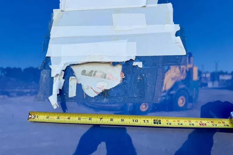 Slide: The Image of Damaged Gulf Crosser 44 boat hull with measuring tape, 2021 model. - 38