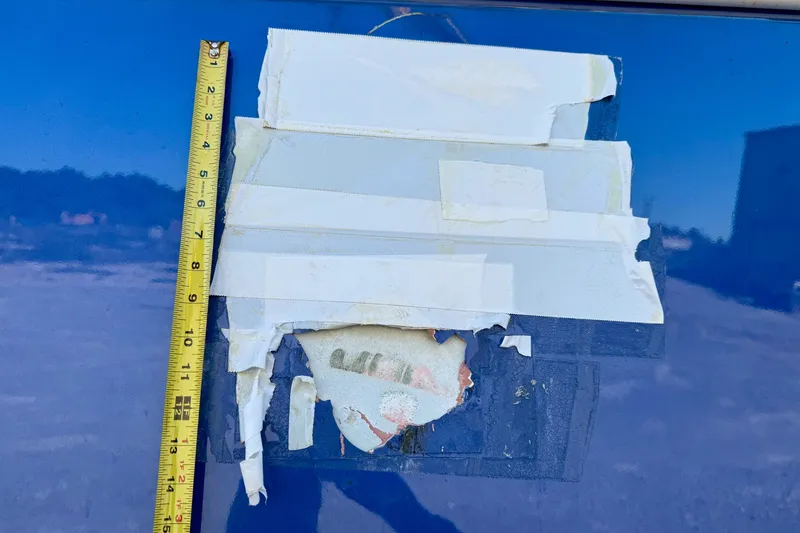 Slide: The Image of Damaged Gulf Crosser 44 boat with peeling tape and visible measuring tape, 2021 model. - 39