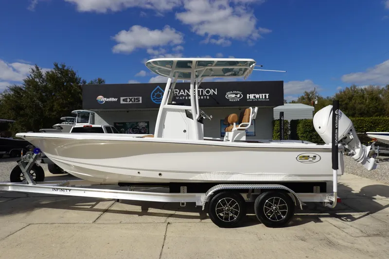 The Image of 2026 Sea Hunt BX 22 BR boat on trailer, displayed outdoors under blue sky. - 0