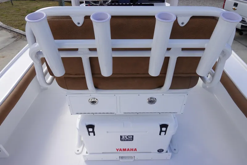 Slide: The Image of 2026 Sea Hunt BX 22 BR boat interior with rod holders and Yamaha cooler. - 15