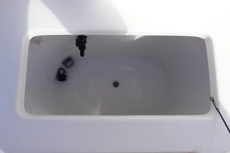 Slide: The Image of Livewell compartment in 2026 Sea Hunt BX 22 BR boat, featuring drainage and fittings. - 26
