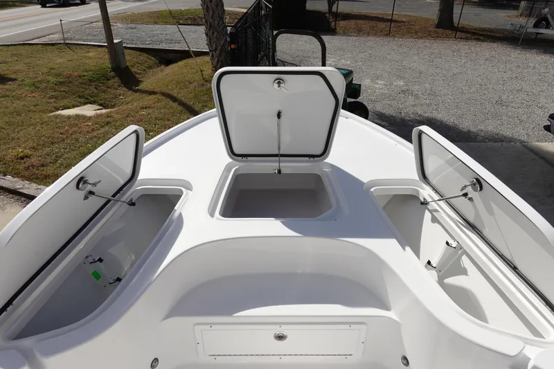 Slide: The Image of 2026 Sea Hunt BX 22 BR boat with open storage compartments on deck. - 29