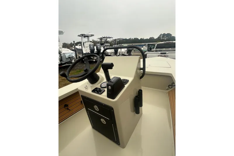 Slide: The Image of 2026 East Cape EVO 18V boat on trailer, displayed outdoors with other boats. - 3