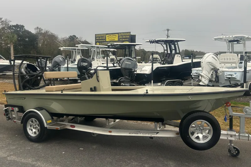 The Image of 2026 East Cape EVO 18V boat on trailer, displayed at dealership with other boats. - 1