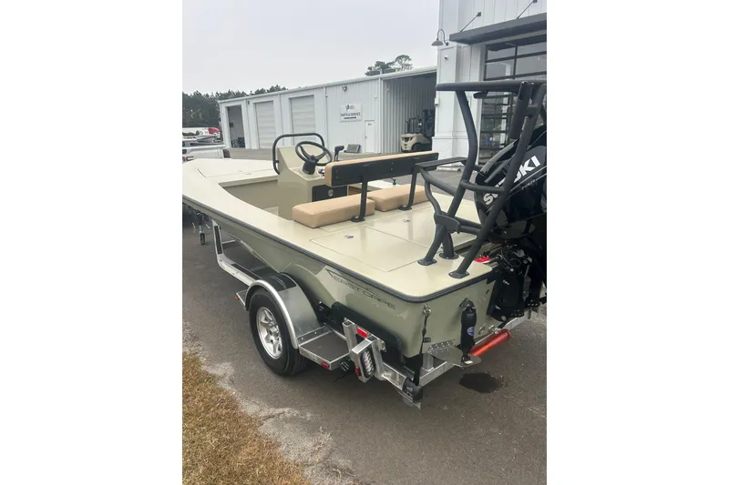 Slide: The Image of 2026 East Cape EVO 18V boat with Suzuki outboard motor in a marina setting. - 6