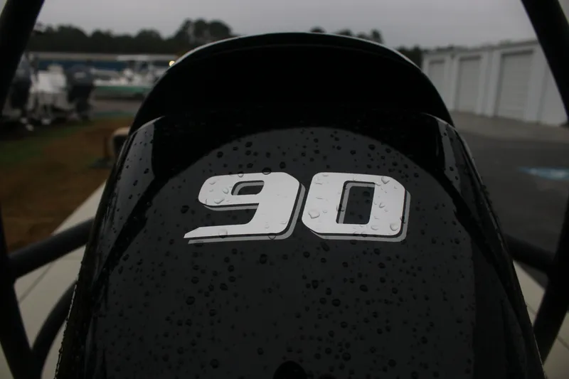 Slide: The Image of Close-up of 2026 East Cape EVO 18V with '90' decal, wet with raindrops. - 7
