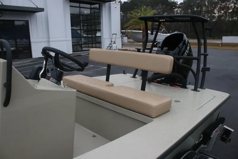 Slide: The Image of 2026 East Cape EVO 18V boat interior with beige seating and steering console. - 8