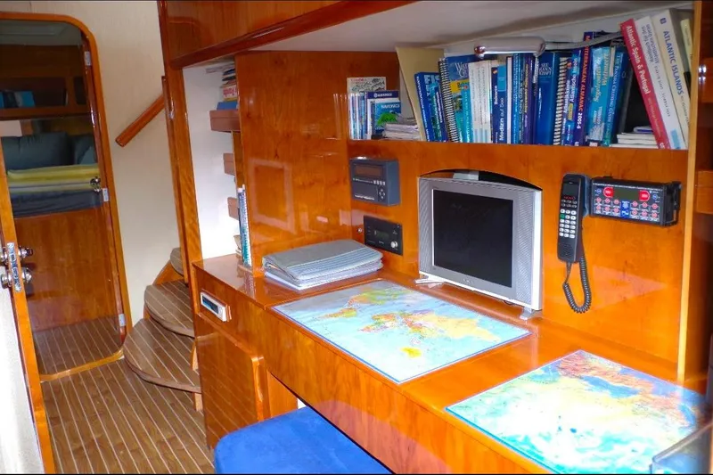 Slide: The Image of Luxurious Privilege 49 yacht interior with navigation desk, maps, and books, 2004 model. - 3