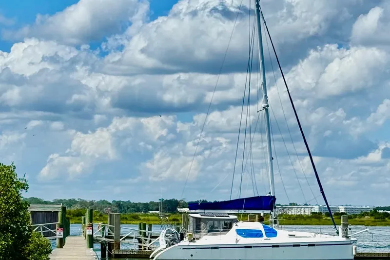 Slide: The Image of Sailboat Privilege 49 docked under a cloudy sky, 2004 model. - 5