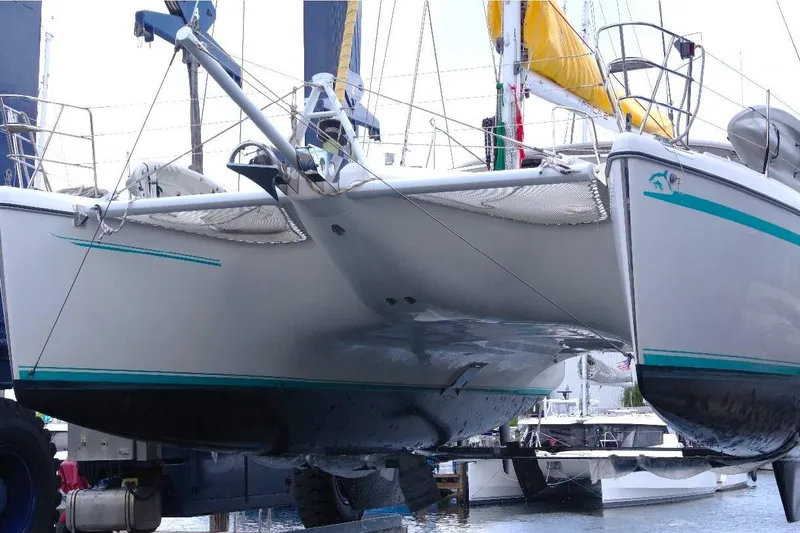 Slide: The Image of Catamaran Privilege 49, 2004 model, docked with visible hull and netting. - 7