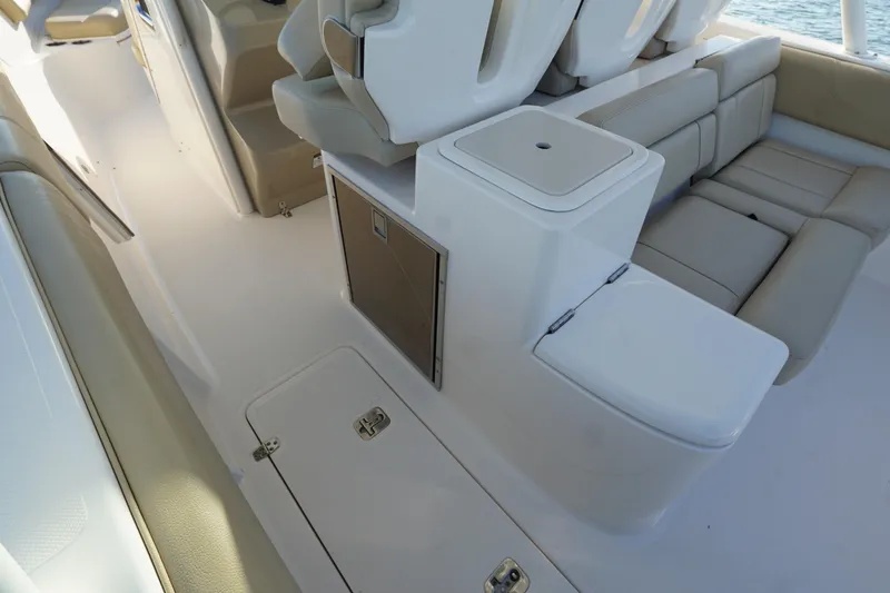 Slide: The Image of 2016 Pursuit ST 310 Sport boat interior with seating and storage compartments. - 14