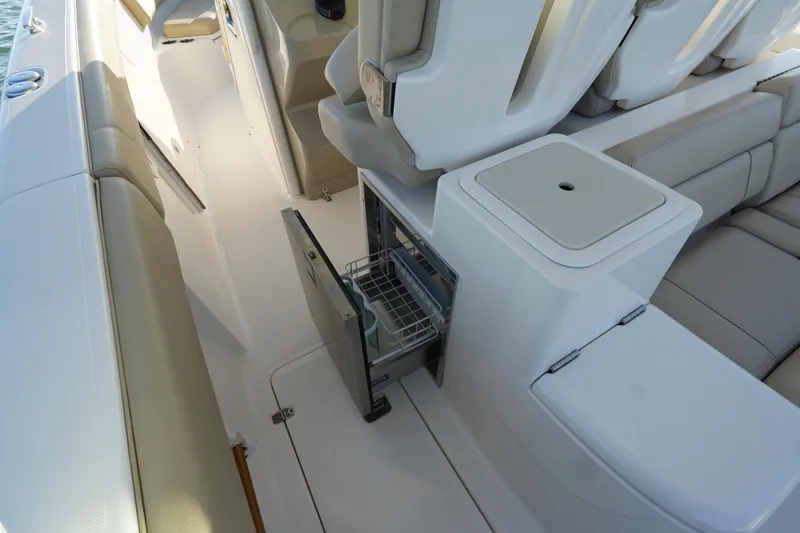 Slide: The Image of 2016 Pursuit ST 310 Sport boat interior with open storage compartment and seating. - 15