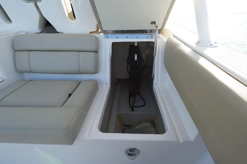 Slide: The Image of 2016 Pursuit ST 310 Sport boat storage compartment with cushioned seating. - 16