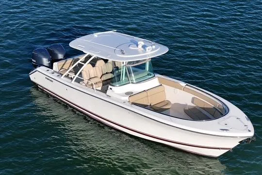 Slide: The Image of 2016 Pursuit ST 310 Sport boat on water, featuring dual engines and spacious seating. - 2