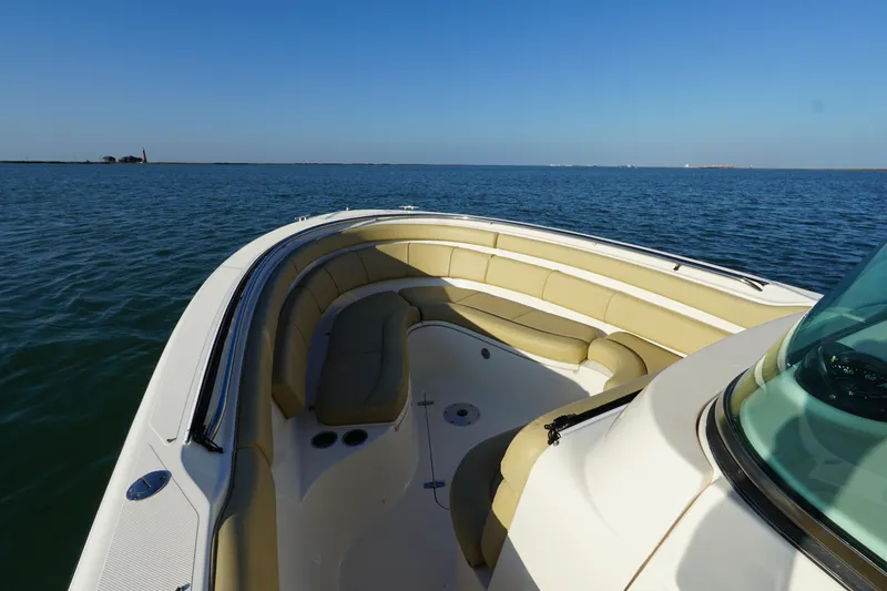 Slide: The Image of 2016 Pursuit ST 310 Sport boat with spacious seating on calm water. - 21