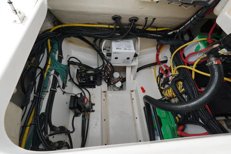 Slide: The Image of Engine compartment of a 2016 Pursuit ST 310 Sport boat, showcasing wiring and components. - 31