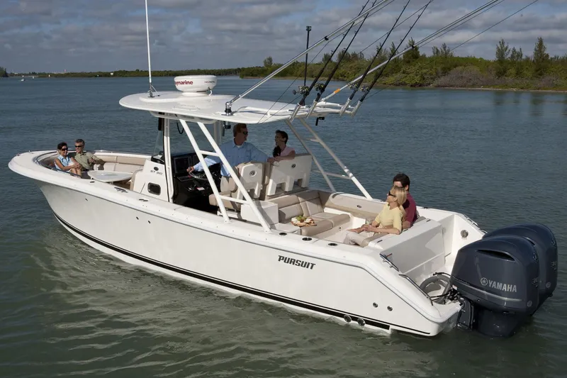Slide: The Image of Manufacturer Provided Image: 2016 Pursuit ST 310 Sport boat cruising with passengers on a calm waterway. - 32