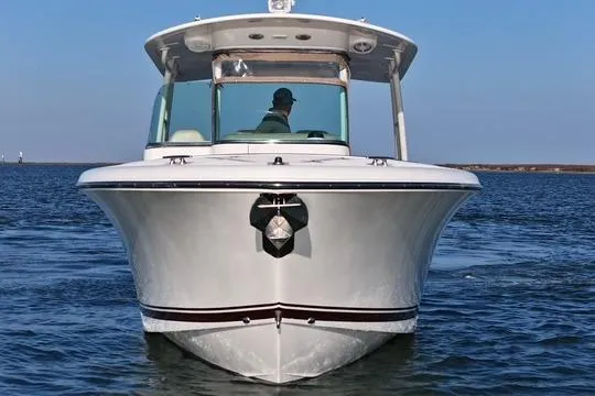 Slide: The Image of 2016 Pursuit ST 310 Sport boat on open water, front view. - 6