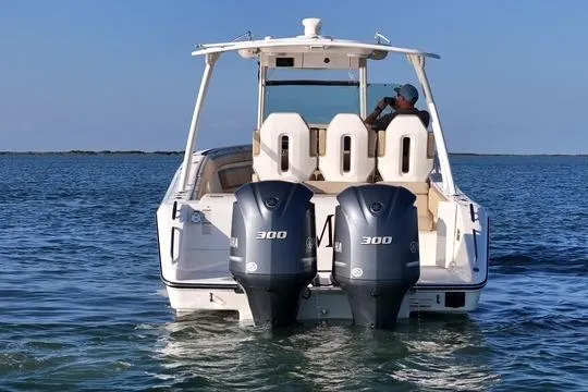 Slide: The Image of 2016 Pursuit ST 310 Sport boat with dual 300 horsepower engines on open water. - 7