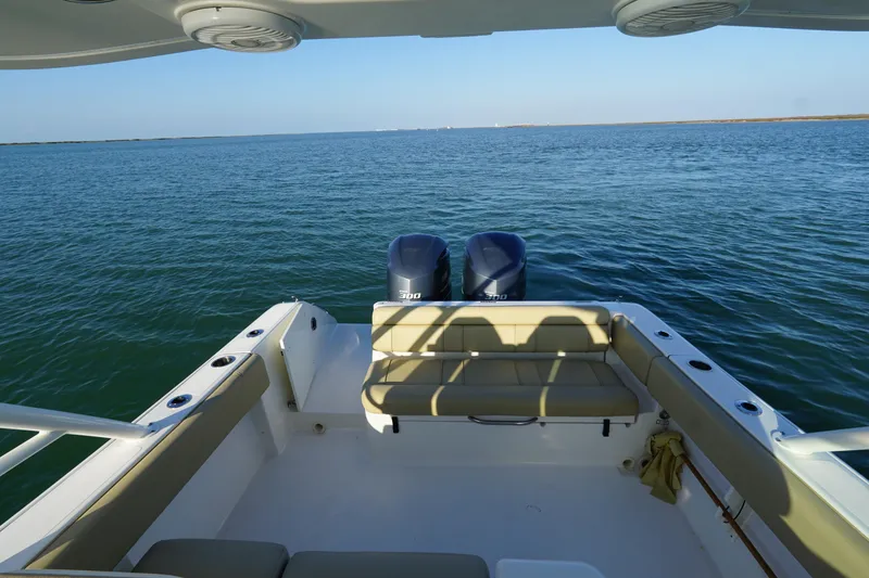 Slide: The Image of 2016 Pursuit ST 310 Sport boat with twin engines on open water. - 9