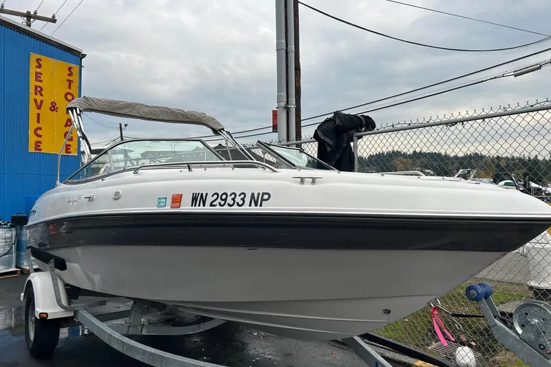 Slide: The Image of 2000 Four Winns 200 Horizon boat on trailer near service and storage facility. - 3