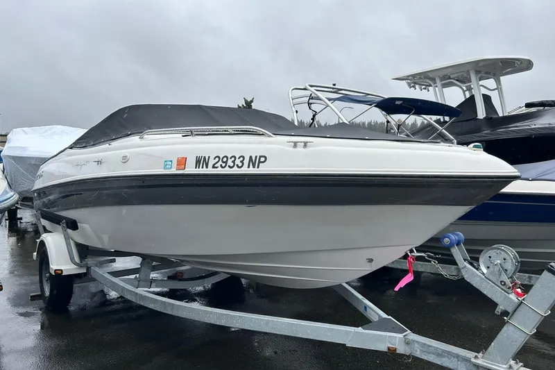 Slide: The Image of 2000 Four Winns 200 Horizon boat on trailer, covered, parked outdoors. - 4