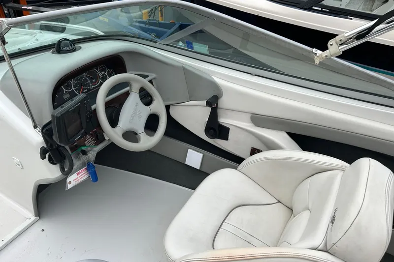 Slide: The Image of Interior of a 2000 Four Winns 200 Horizon boat, featuring steering wheel and dashboard. - 6